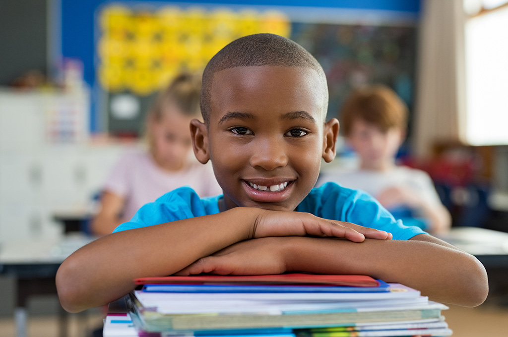 iStock 950608328 boy in school on desk 1000